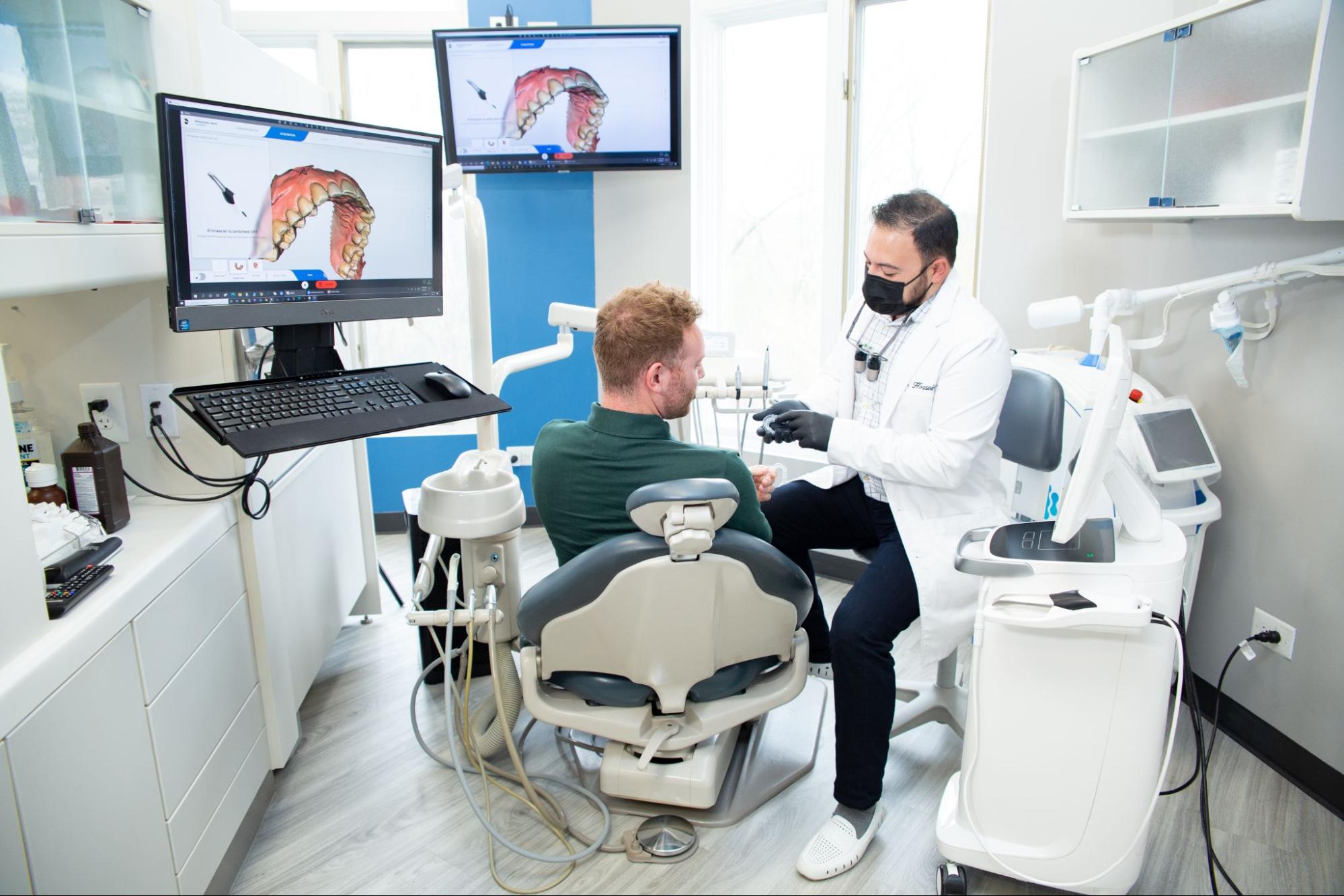 image1 Dr. Hosseini talking to a male patient.